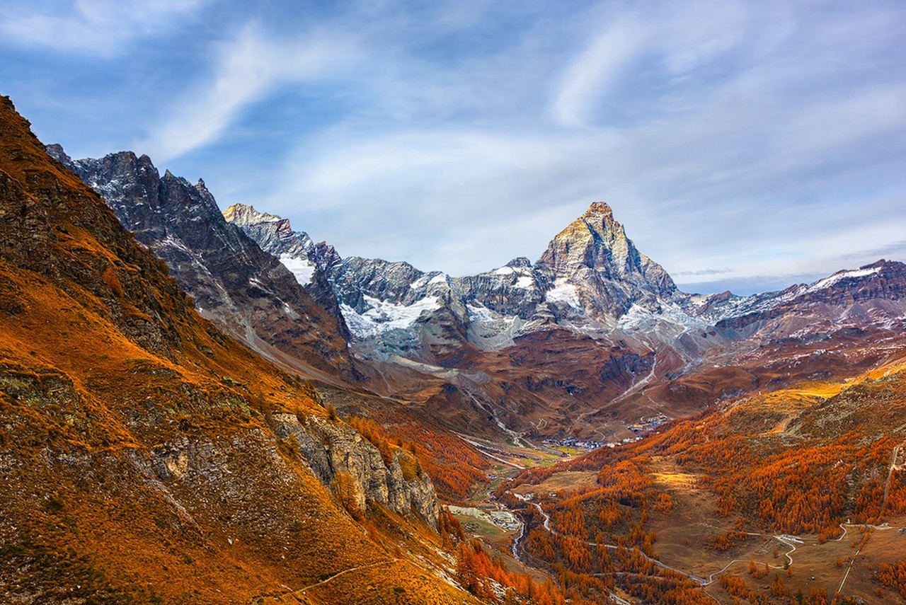The Matterhorn rises above an autumn-colored valley.